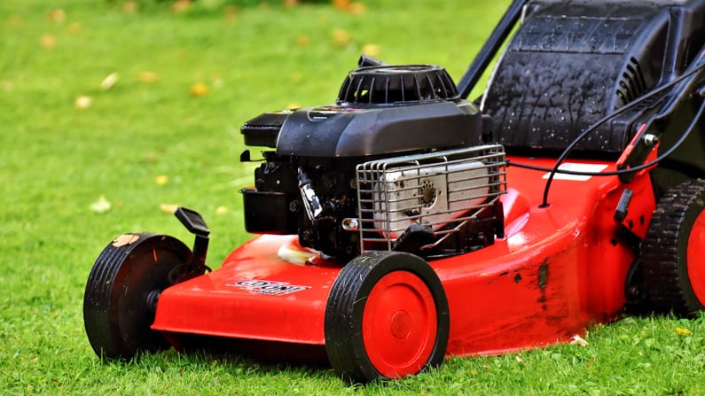 red lawnmower on a green lawn