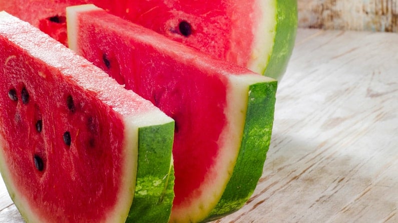 sliced watermelon sitting on a counter