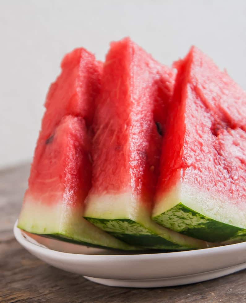 three slices of watermelon on a plate